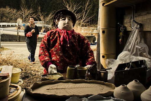 Tsukimi Ayano walks towards a scarecrow, which she made as a likeness of herself, in the mountain village of Nagoro