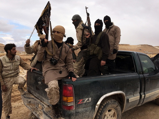 Al Qaeda-linked Nusra Front fighters carry their weapons on the back of a pick-up truck during the release of Lebanese soldiers and policemen in Arsal, eastern Bekaa Valley, Lebanon