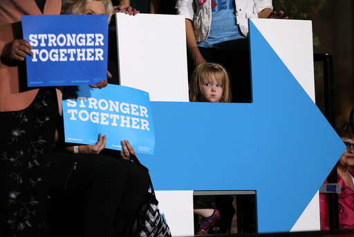 A girl listens to U.S. Democratic presidential nominee Hillary Clinton as she speaks at a rally in Las Vegas