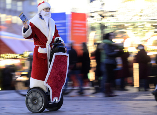 A man dressed as Santa Claus rides his Segway as he delivers gifts at the Christmas market in Hamburg