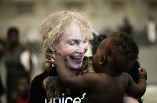 US actress Mia Farrow, a UNICEF goodwill ambassador, smiles as she holds a Haitian baby during her visit to a shelter in the town of Gonaives