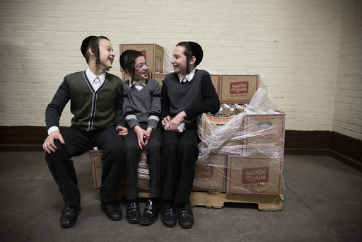 Children sit on a pile of boxes at a mass gathering of Satmar Hasidic Jews in New York