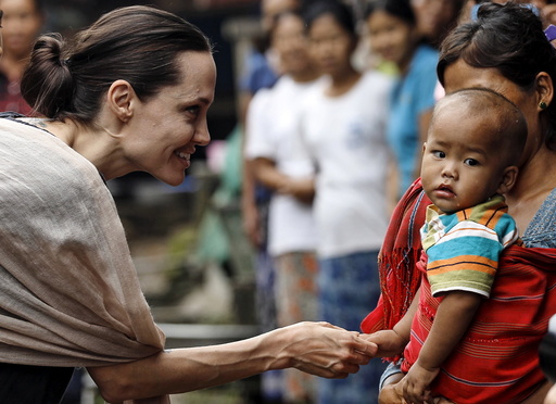 UNHCR special envoy Jolie Pitt shakes hand with Kachin ethnic refugee kid as she visits Jam Mai Kaung IDP camp in Myitkyina capital city of Kachin state